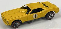 Left front view of yellow 1969 Hot Wheels Snake Funny Car showing body, wheels, door decal
