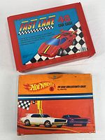 Front view of both car cases: red Fast Lane 48-car case and orange Hot Wheels 24-car case