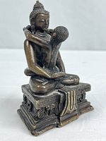 Front left view of bronze Yab-Yum figure on pedestal