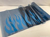 rolled metallic blue flame decal on transfer liner