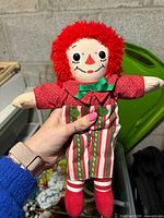 Front view of Raggedy Andy cloth doll showing facial details, clothing and overall condition