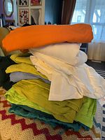 Stack of assorted coloured linens on a surface