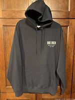 Front view of black Big Rock Brewery pullover hoodie showing logo and kangaroo pocket