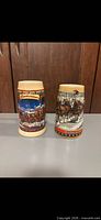 Front view of both Budweiser holiday steins