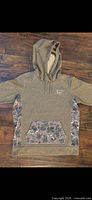 Front view of Burton floral hoodie showing color, pattern, hood, pocket