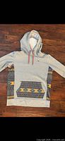 Front view of Burton hoodie showing color, pattern, pocket and hood