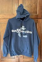 Full view of navy Walt Disney World Mickey Mouse hoodie on hanger