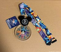 Full view of lanyard showing strap pattern, reel, medallion and attached tag