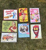Group shot of seven signs laid out on grass