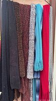 All nine scarves hanging to show colours, textures and lengths