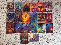 Front view of 18 Marvel trading cards laid out, showing character art and condition