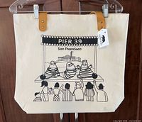 Front view of tote bag showing graphic and straps