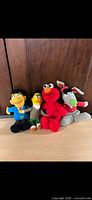 Front view of four plush toys standing side by side