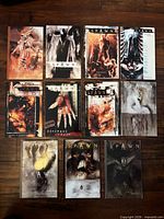 Group shot of all eleven Spawn books laid out on wood floor