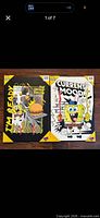 Both factory-packed posters side by side showing graphics and corner protectors