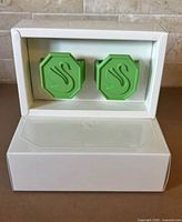 Pair of green silicone Swarovski napkin rings in presentation box