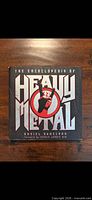 Front cover of The Encyclopedia of Heavy Metal hardcover showing title and graphics