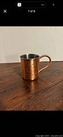 Front view Tito's copper Moscow Mule mug showing logo and handle