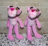Front view of both Pink Panther plush toys standing upright