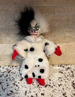 Front view of plush doll showing coat, face, and coloration