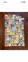 Full layout of roughly 80 colourful Disney 100 trading cards on floor