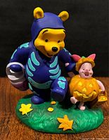 Front view of Pooh and Piglet figurine on base