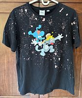 Front of black Zara T-shirt showing Itchy & Scratchy graphic and paint-splatter design