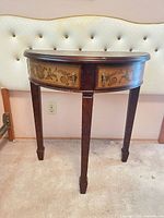 Full view of demi-lune console table showing painted panels, legs, and overall condition