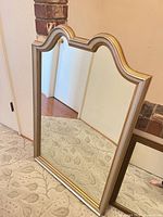 Front view of arched gilt wall mirror