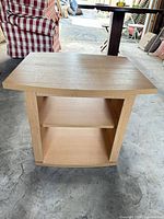 Full view of light oak side table with shelves