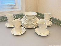 Full set stacked: cups, saucers, plates, bowls