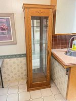 Full view of oak curio cabinet in kitchen setting