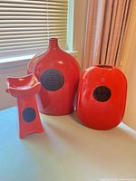 Group shot of all three red ceramic pieces