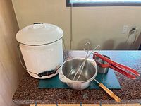 group shot showing chamber pot with lid, mixing bowl, tongs, red-handled potato masher