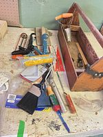 Overall view of toolbox and assorted tools on bench