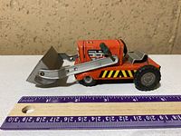 Side view showing full loader, shovel, wheel details and ruler for scale
