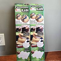 Front view of two sealed Furniture Lift boxes standing side by side