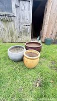 Three planters placed on grass showing overall condition and colors