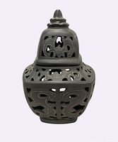 front view of black incense burner showing cut-out design and lid