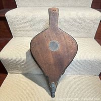 Front view showing wood board with mesh intake and leather sides