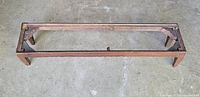 Wood frame of kneeling bench, top removed showing structure