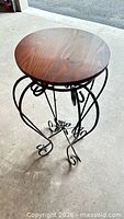 Full view of accent table showing wood top and iron base
