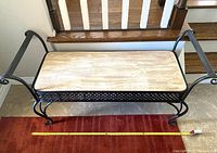 Full view of bench showing metal frame, wood seat and overall style
