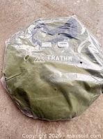 Front view of sealed Trathm carry bag showing logo and packaging.
