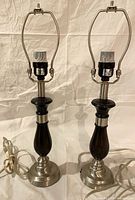 Pair of matching black and nickel lamps standing side by side