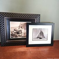 Both framed sailing photographs side by side