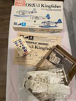 Box top, instruction sheet, decal sheet, promotional sheet and sealed sprues of MPC Profile Series OS2U-3 Kingfisher kit