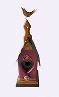 Full view of birdhouse showing shape, colors and metal roof