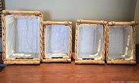 All four lined wicker baskets upright showing overall condition and liners