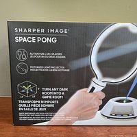 Front of box showing Sharper Image Space Pong branding
